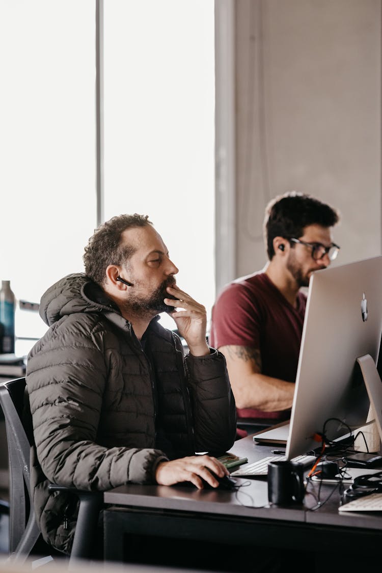 Men In The Office Using Computers 