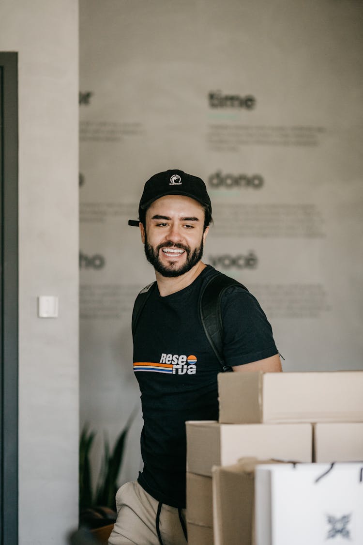 Man Walking Near Boxes In Office