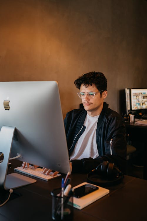 Man in Jacket Sitting and Working