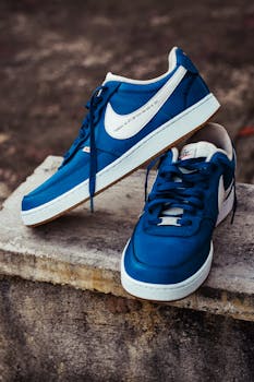 Close-up of trendy blue sports shoes on a concrete block outdoors.