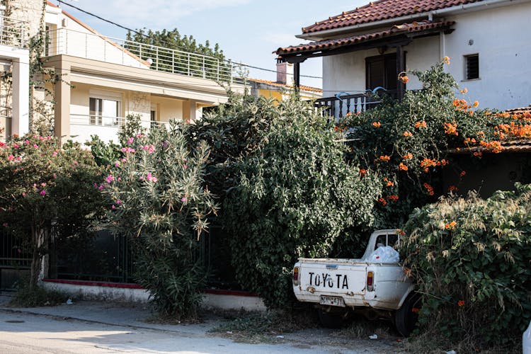 Pick Up Truck Parked Beside A House