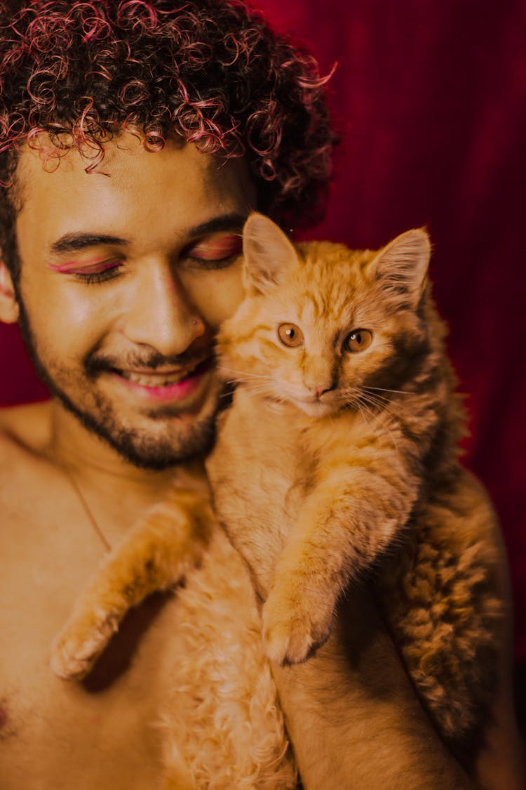 Topless Man Holding Brown Cat