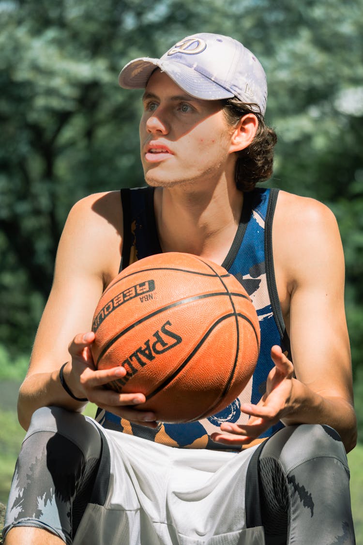 Sitting Man Holding Basketball