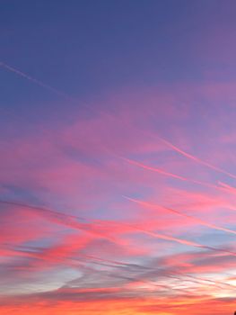 Vibrant pink clouds during sunset creating a dramatic sky and tranquil atmosphere.