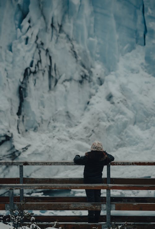 Person Looking at a Snow Covered Mountain