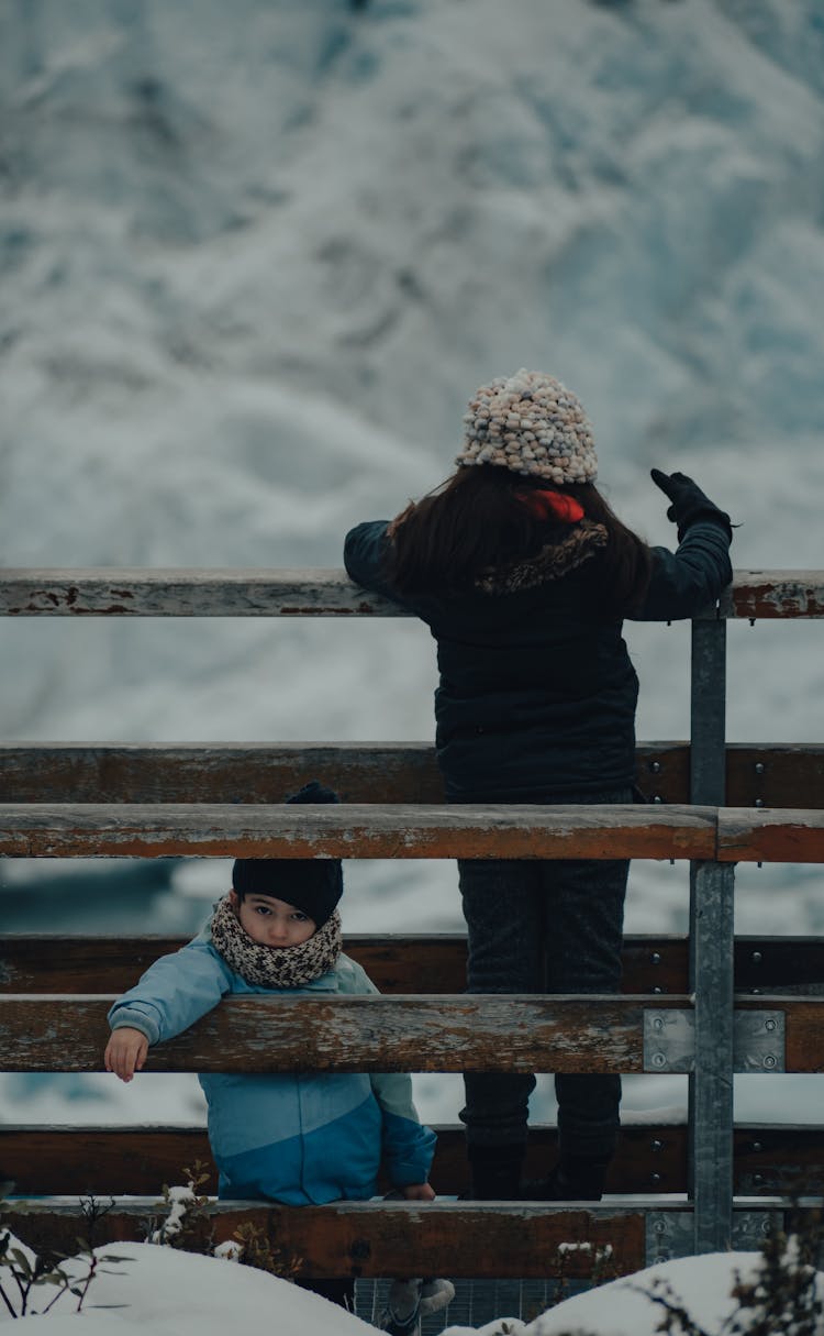 Children Standing On A Footbridge In Winter