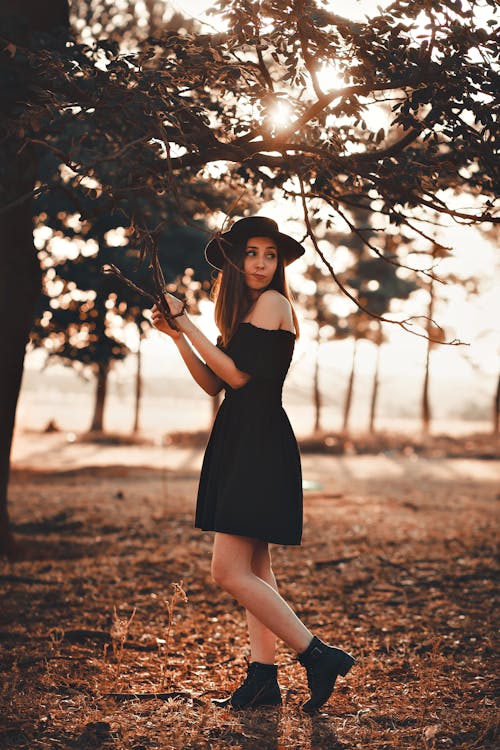 Woman in Black Dress Standing Under the Tree