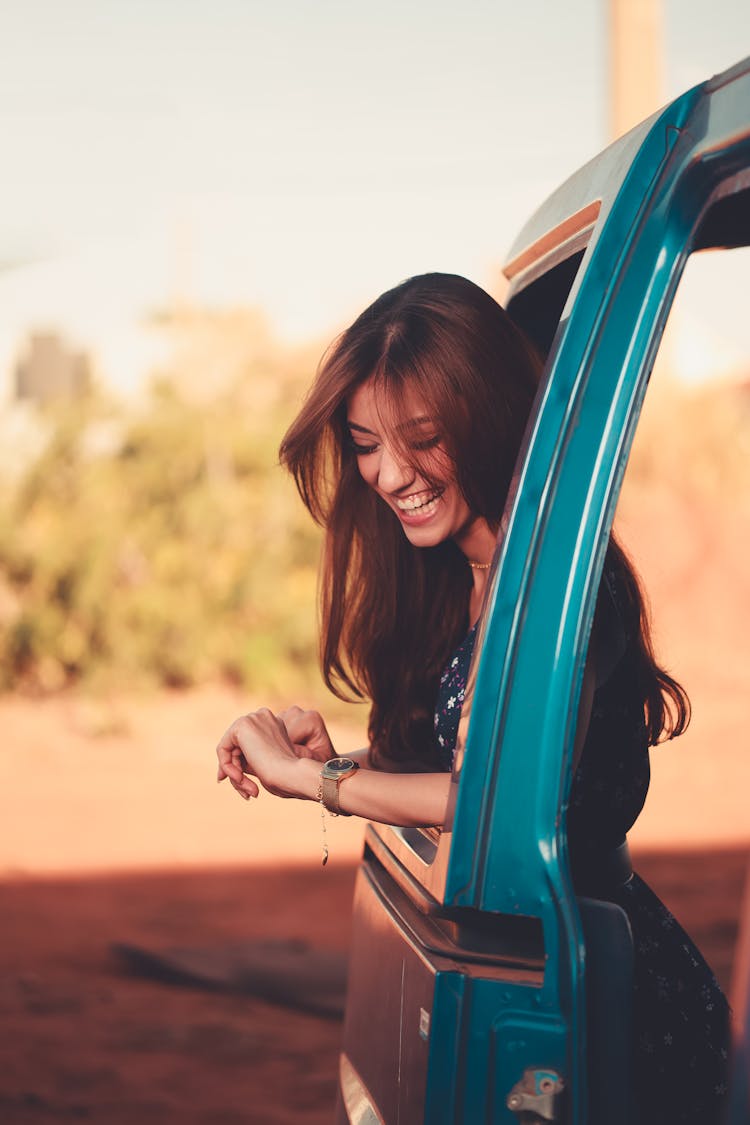 Smiling Woman Looking Out Of Car Window