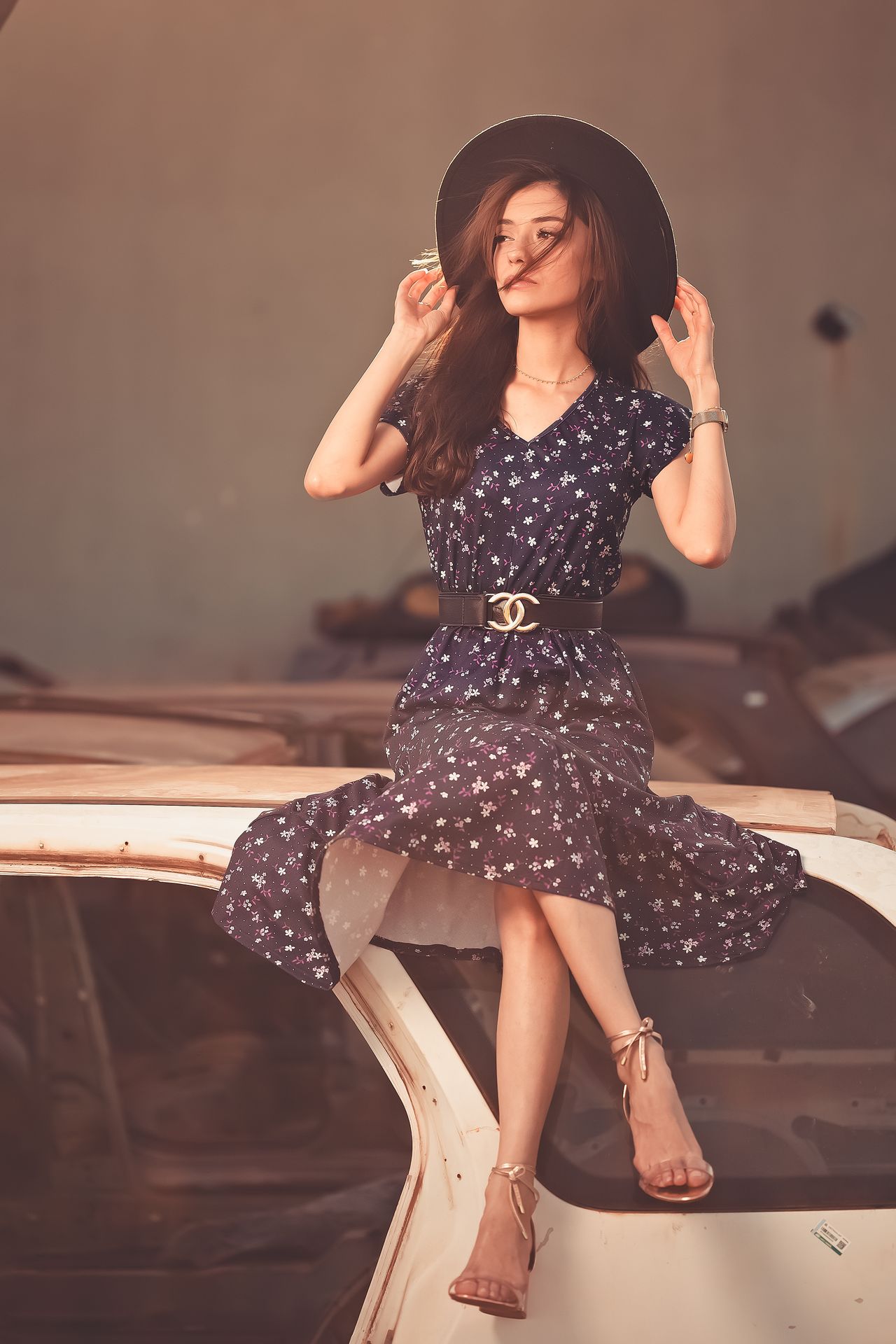 Woman in a floral midi dress and wide-brim hat