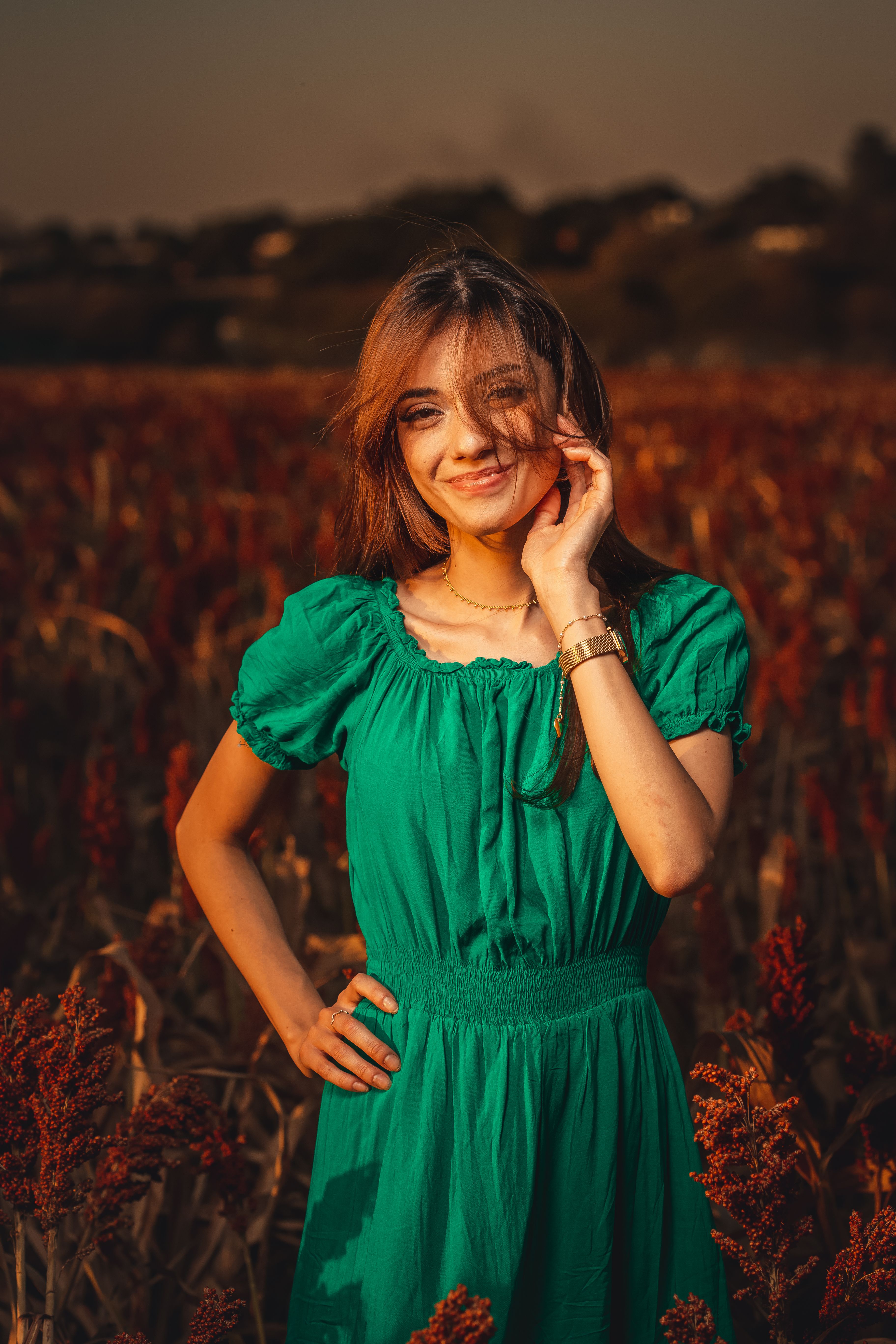 Woman in Green Dress Standing on Brown Grass Field  Free Stock Photo