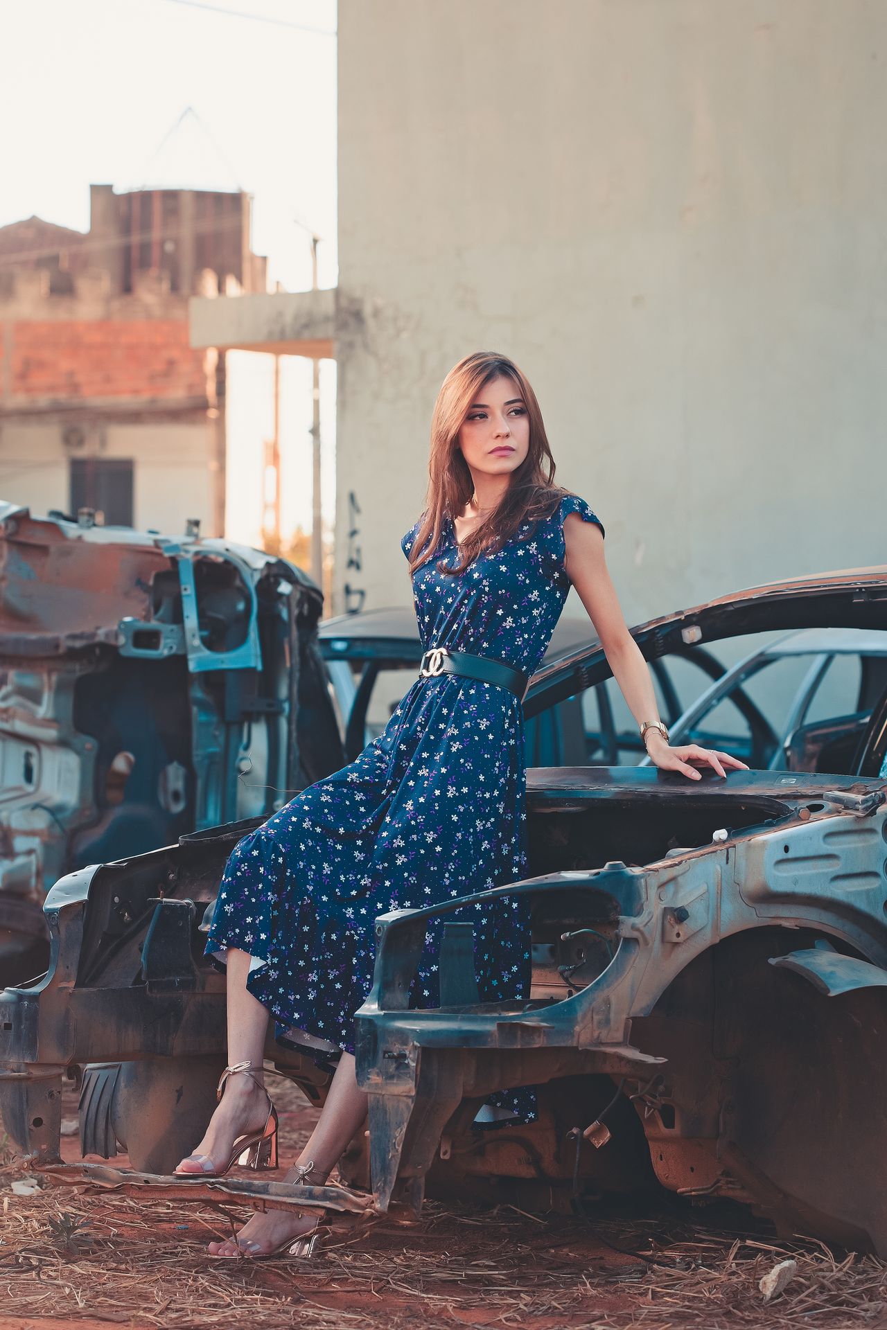 Woman in a navy floral midi dress with a belt