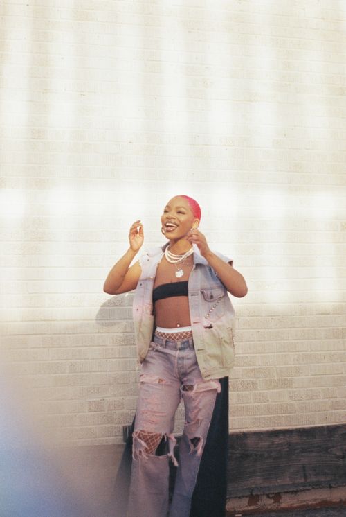 Free Stylish young woman with pink hair in vibrant denim against a bright wall, showcasing modern fashion. Stock Photo
