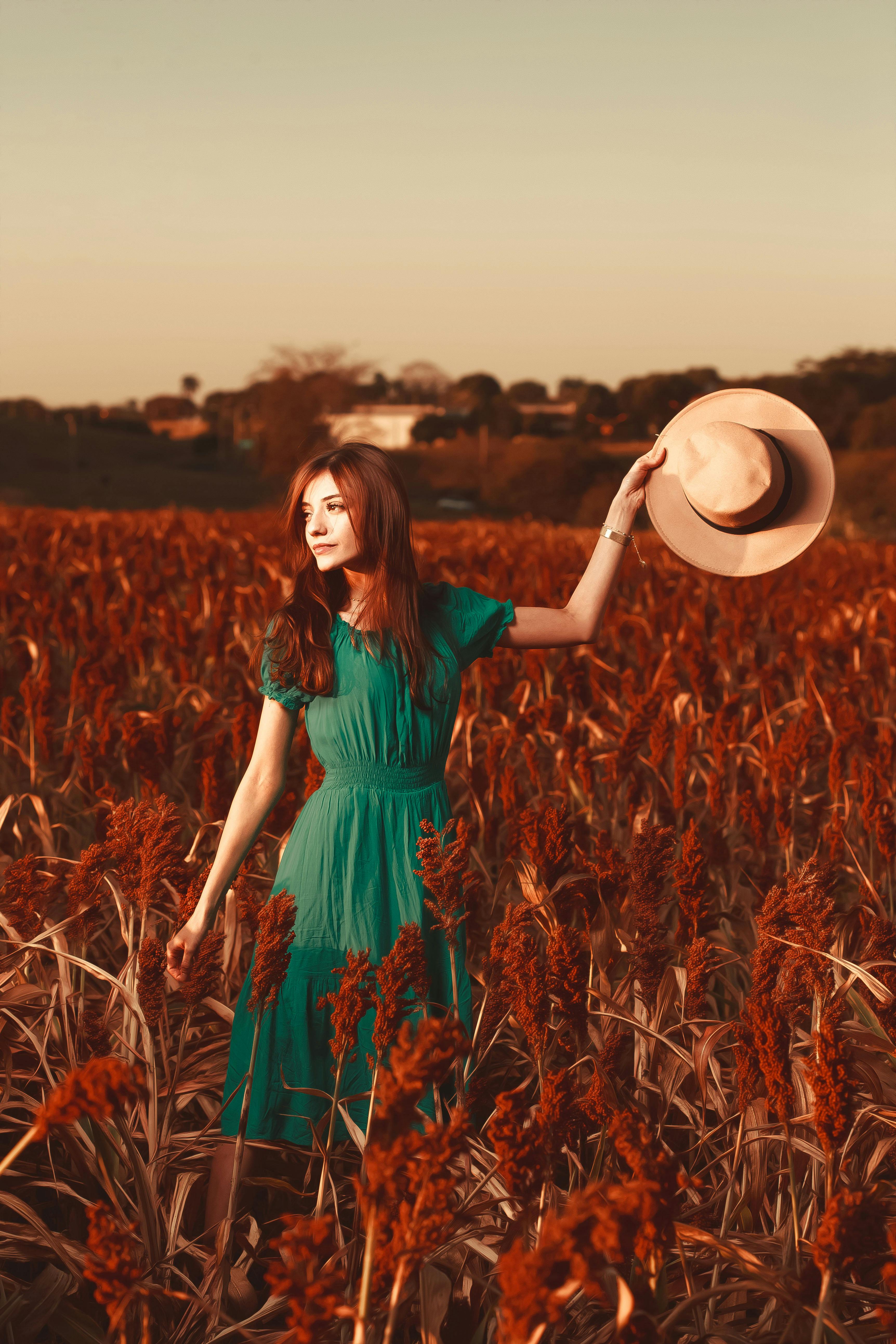 Woman in Green Dress Standing on Brown Grass Field · Free Stock Photo