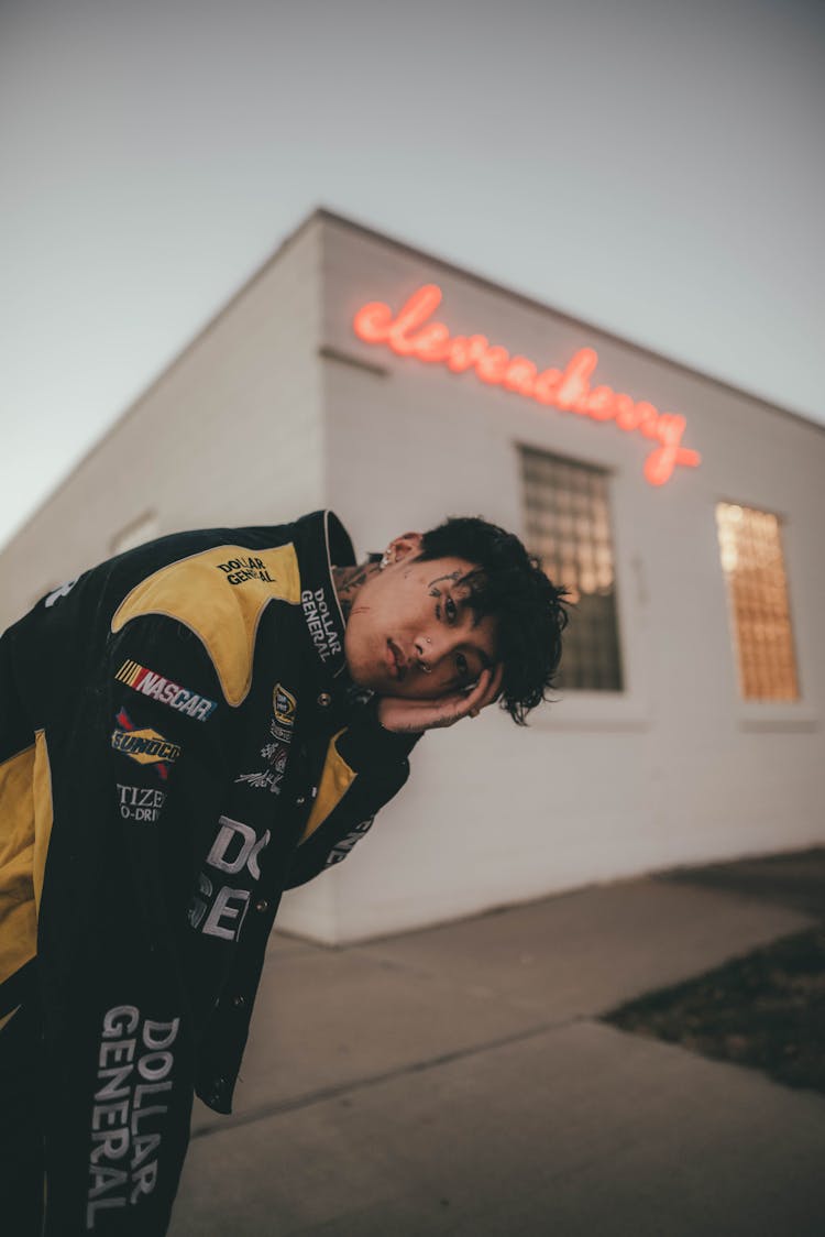 Young Man In Motor Jacket Posing Outdoors