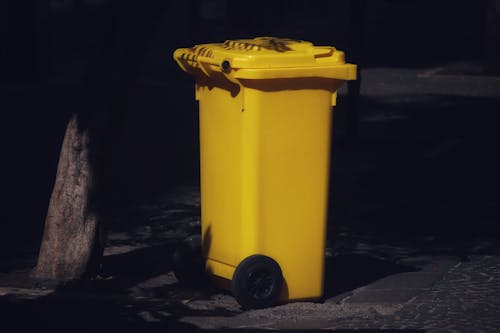 Free Yellow Plastic Trash Bin Stock Photo