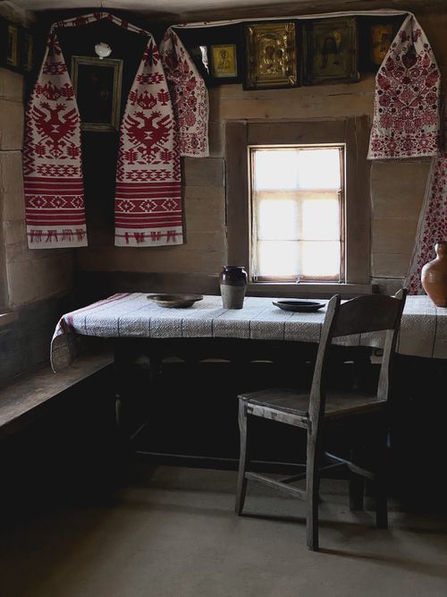 Free Cozy interior of a rustic dining room featuring traditional textiles and pottery. Stock Photo