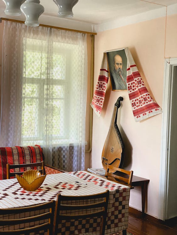 Stringed Musical Instrument on Brown Table · Free Stock Photo