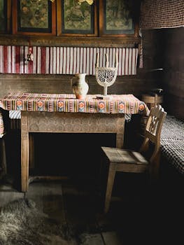 Cozy rustic interior with wooden furniture and colorful traditional textiles.