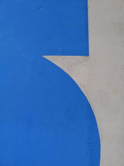 Free Close-up of abstract geometric design with blue paint on concrete wall surface. Stock Photo