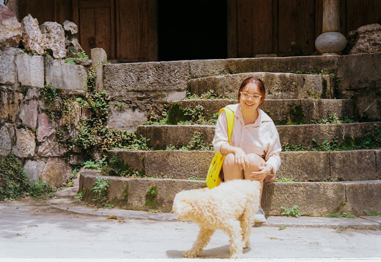 A Woman Sitting Beside Her Pet Dog