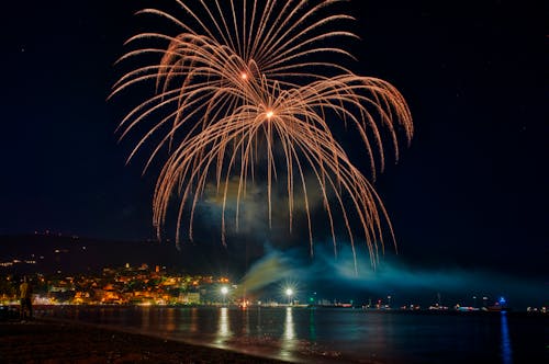 Fireworks Display over Body of Water during Night Time