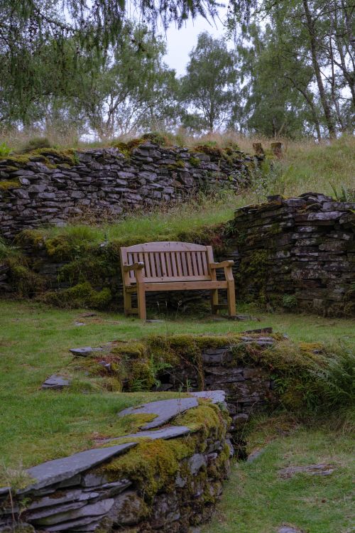Wooden Bench near a Stone Wall · Free Stock Photo