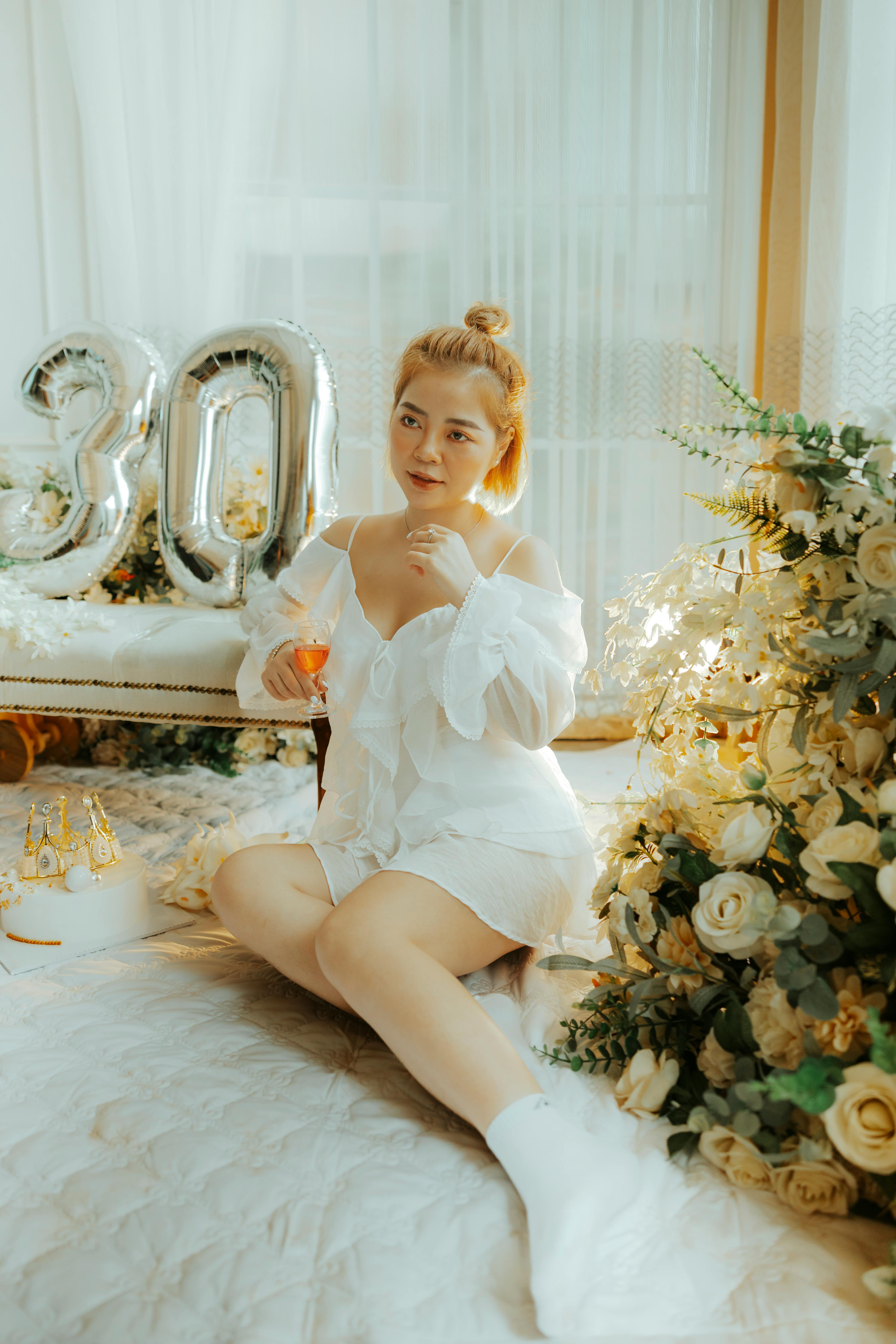 woman in white dress sitting on the floor