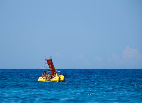People Sailing in a Pedal Boat on the Sea 
