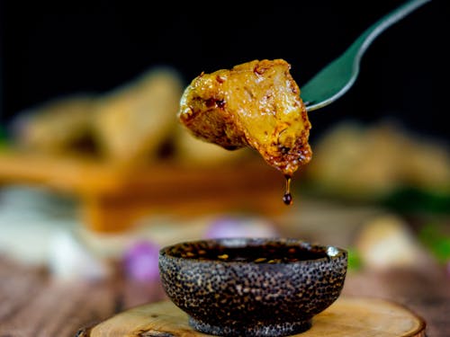 Close-Up Shot of Orange Food on Fork