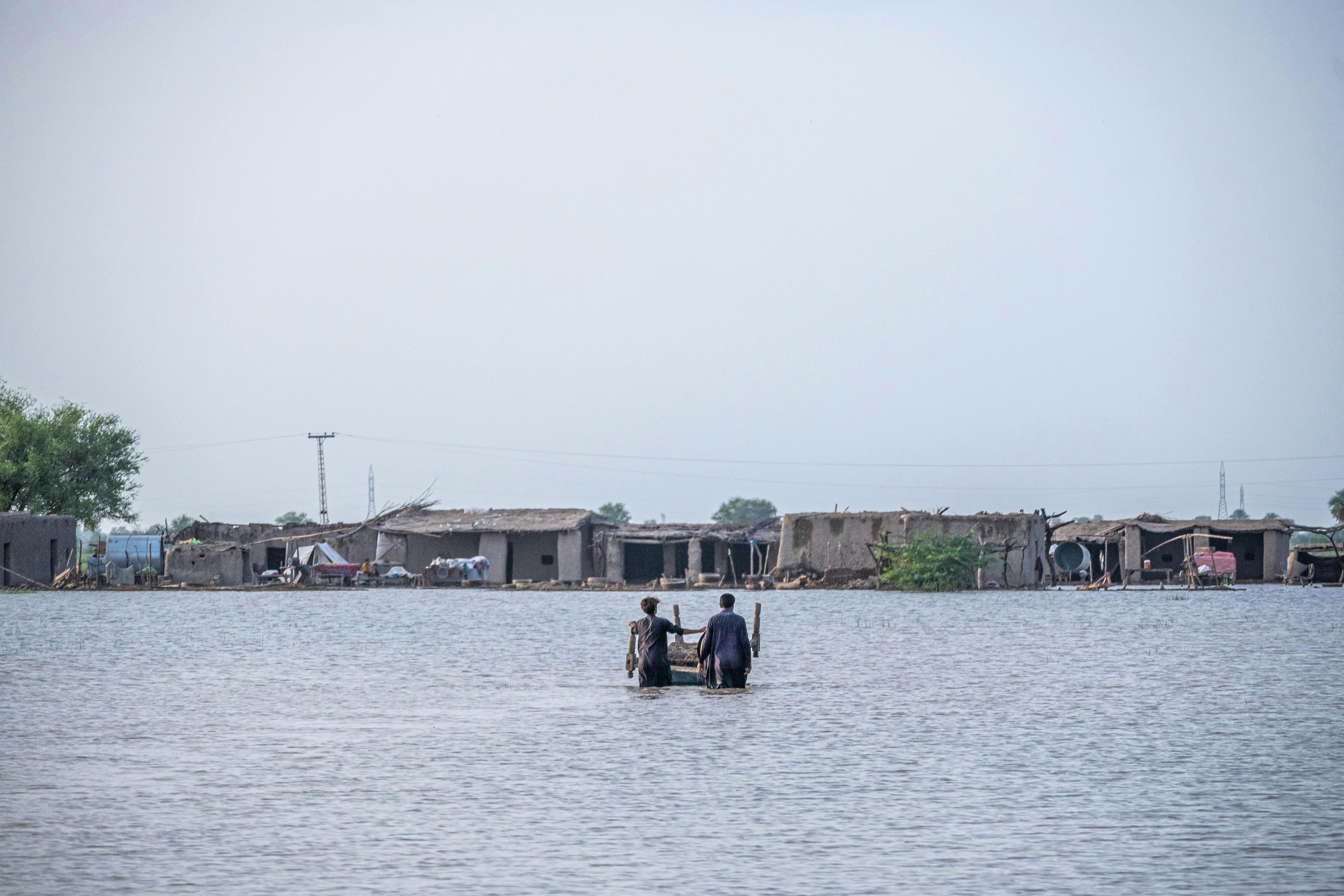 People Standing Knee Deep in Flood Water