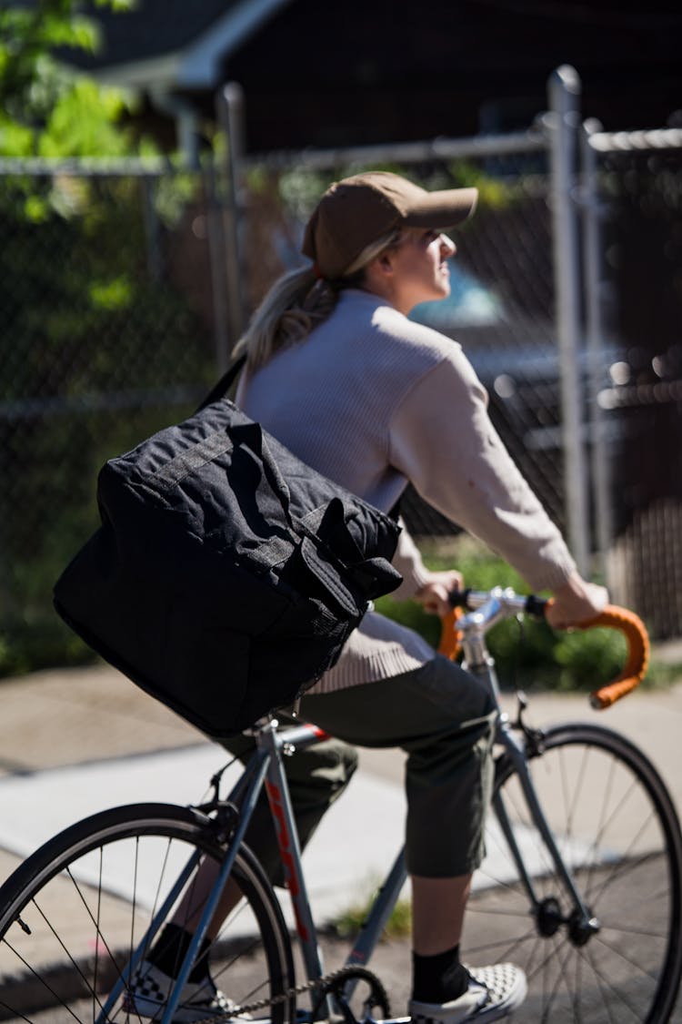 Woman Riding A Bicycle With A Food Delivery Bag 