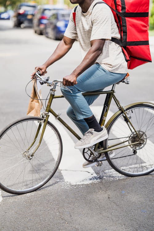 Man Riding a Bicycle with a Food Delivery Bag · Free Stock Photo