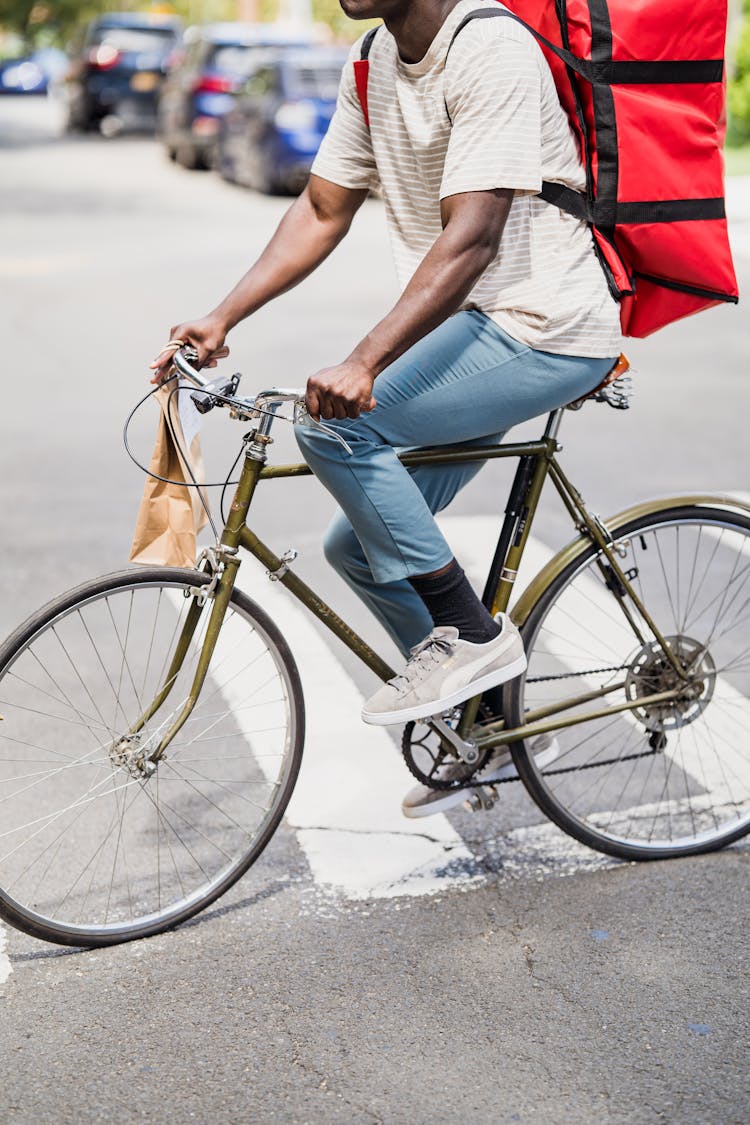 Man Riding A Bicycle With A Food Delivery Bag 
