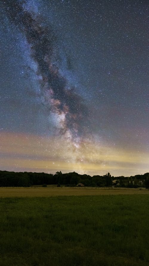 Milky Way Galaxy in the Sky over a Meadow at Dusk 
