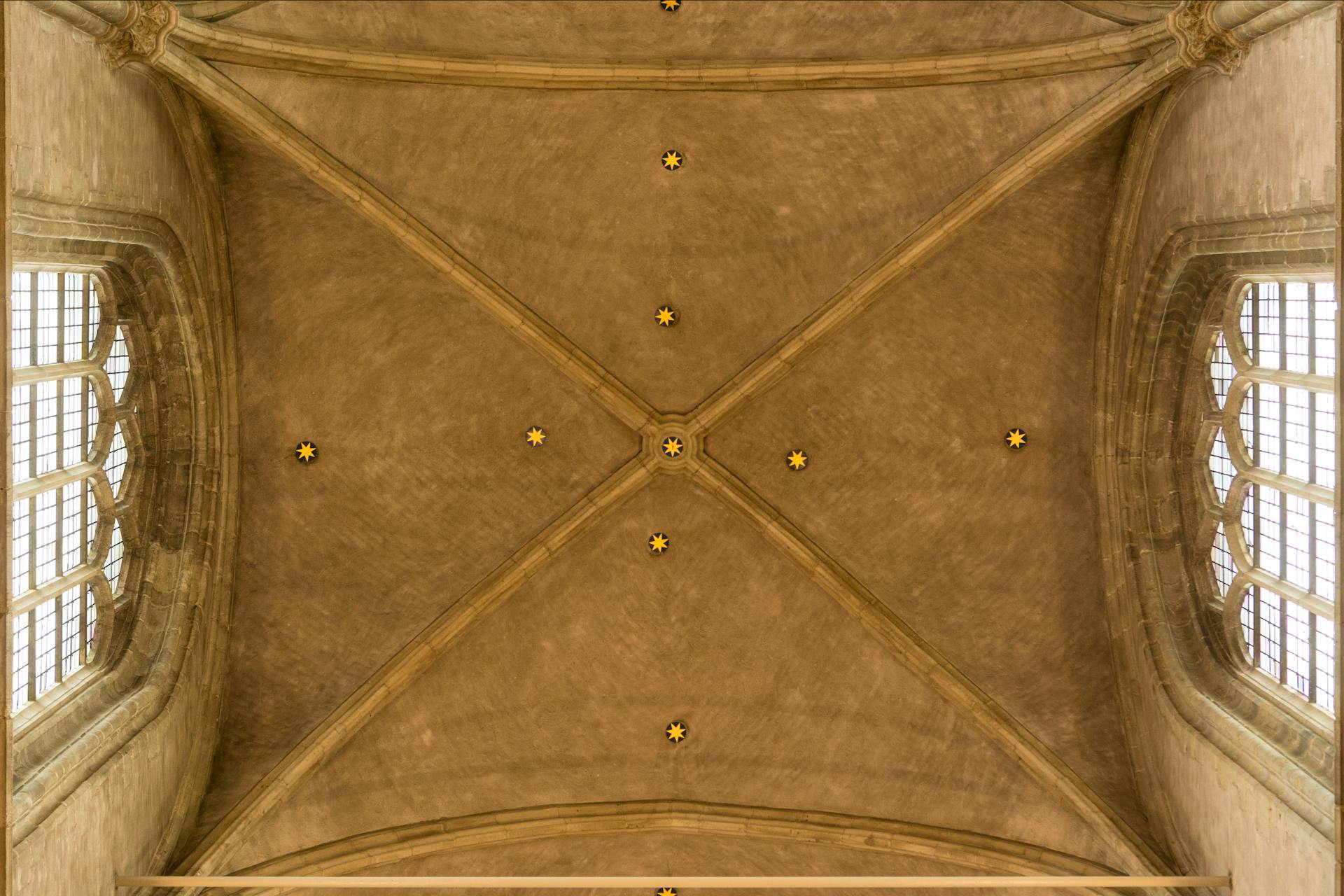 Intricate gothic ceiling architecture featuring cross vaults and pointed arches.