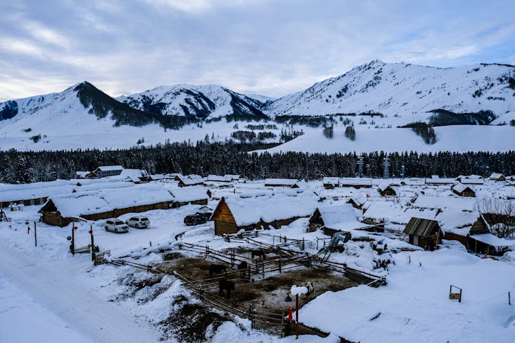 Snow Covered Mountain Near Cabins