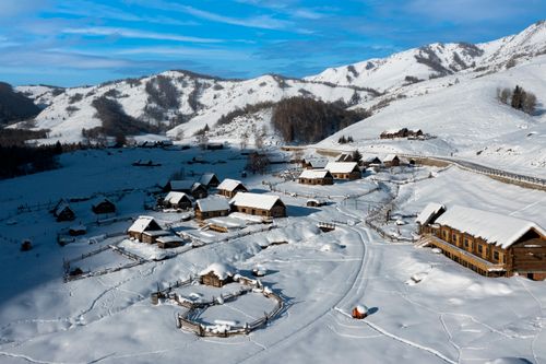 Free A winter aerial view of a snow-covered village in Altay Prefecture, Xinjiang, China. Stock Photo