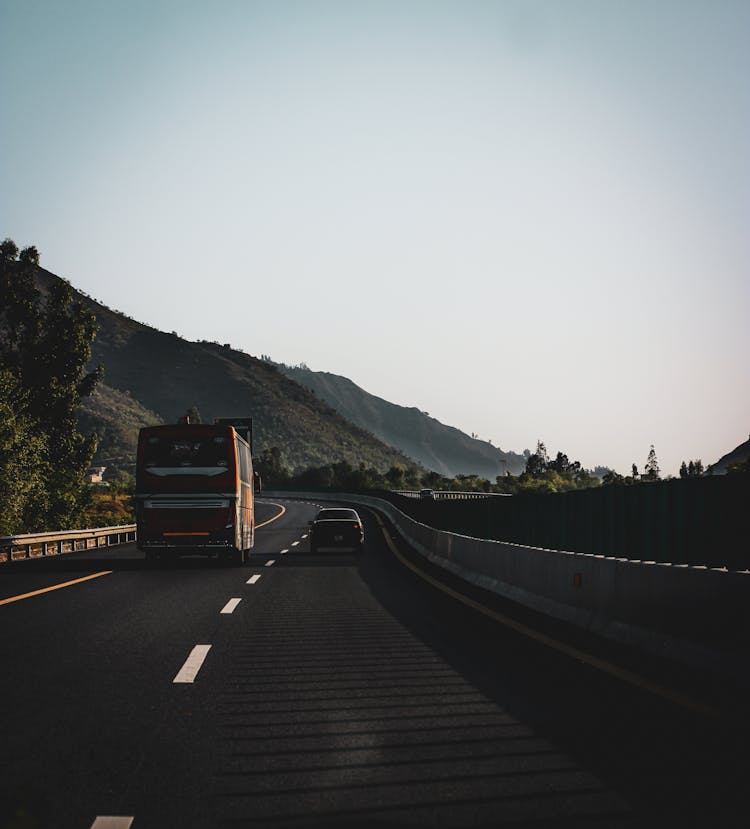 Bus And Car Driving At The Highway