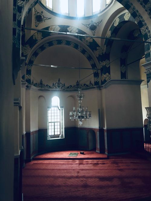 Free Serene interior shot of a sacred space with ornate architecture and a chandelier. Stock Photo