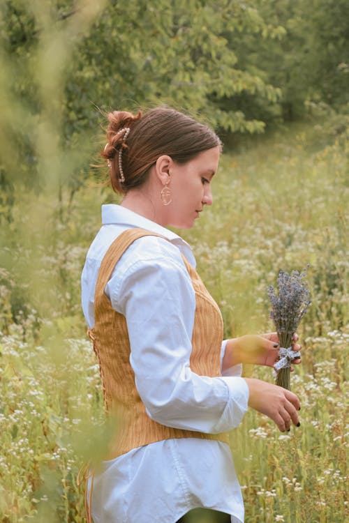 Beautiful Woman standing on a Flower Field