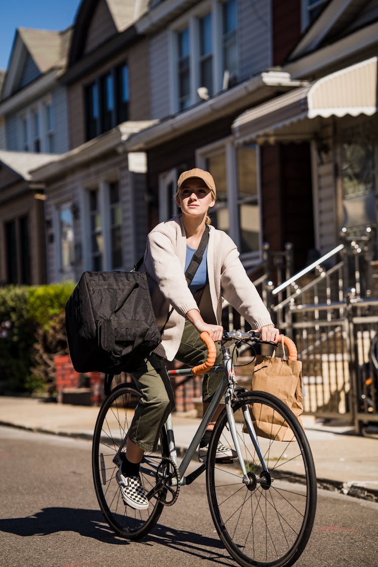 Woman Riding A Bicycle With A Food Delivery Bag 
