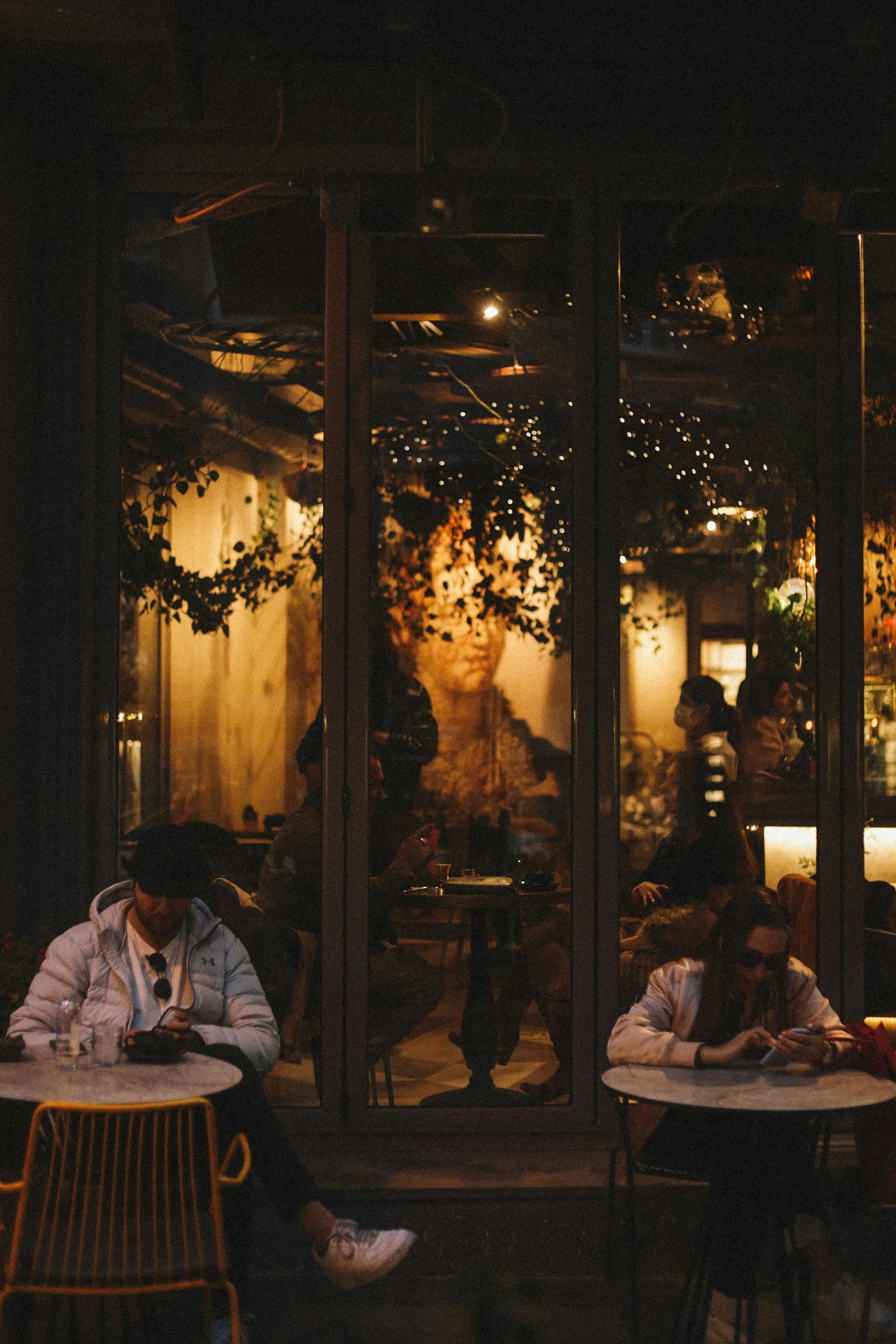 man and a woman browsing their smartphones