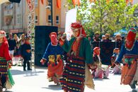 Colorful traditional attire worn by dancers at an outdoor cultural festival.