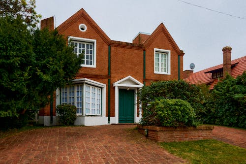 Brick House with Bushes and Trees 