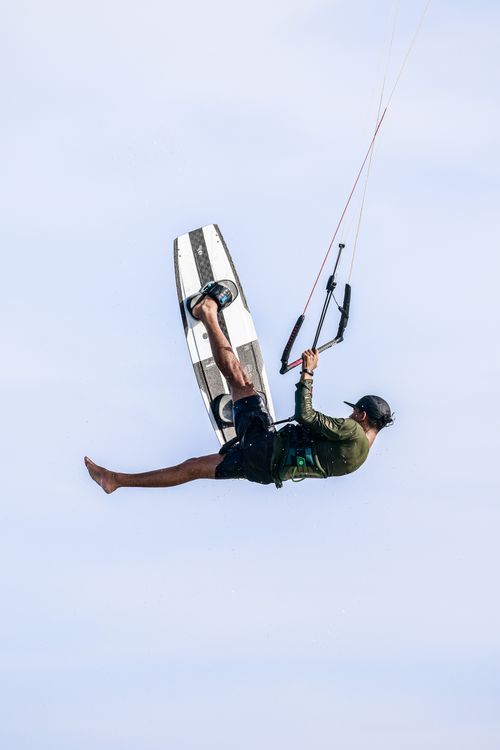 Free Kiteboarder performing aerial tricks over clear sky in Adicora, Venezuela. Stock Photo