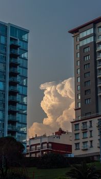 Vertical view of buildings framing a dramatic cloud formation in Mar del Plata, Argentina.