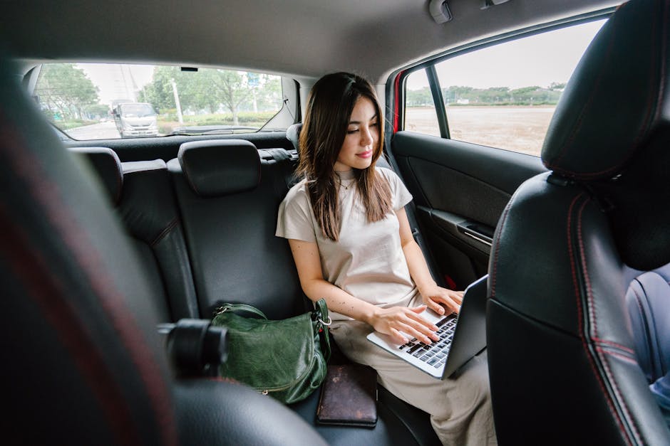 Woman Using Laptop Computer Inside Vehicle