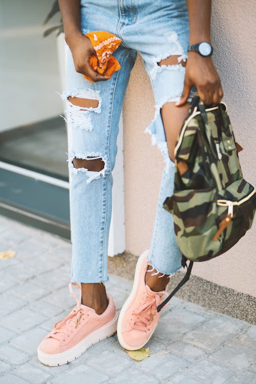 Free Woman Leaning on Wall Carry Camouflage Backpack Stock Photo