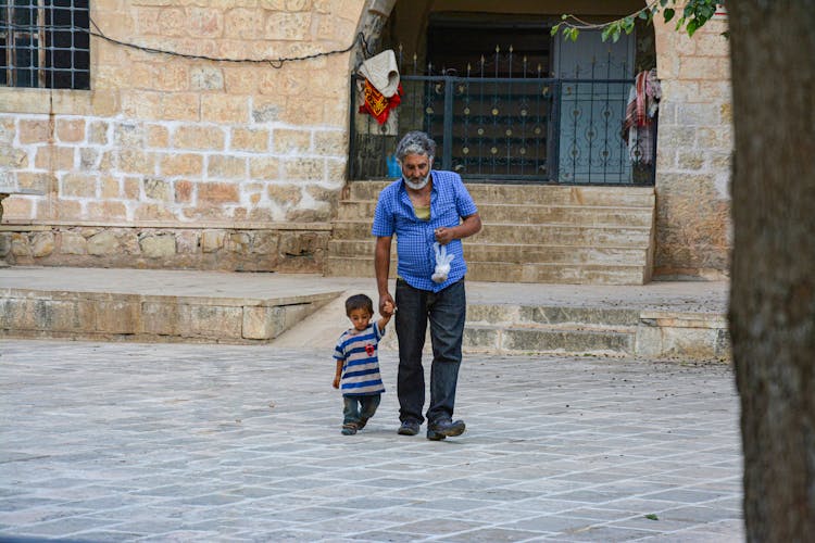 Father And Son Walking On The Street