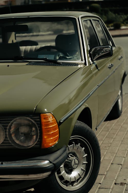 Green Car Parked on Pavement